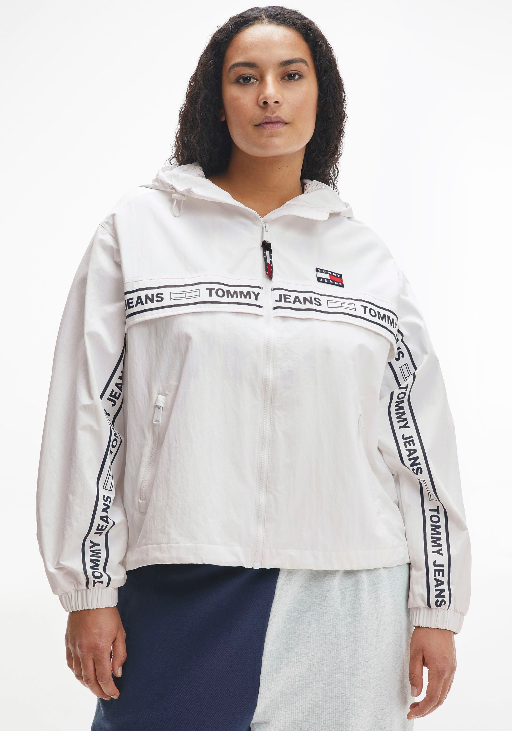 Tommy Jeans Curve Windbreaker »TJW CRV CHICAGO TAPE«, Mit verstellbarer Kapuze und Tommy Jeans Logoschriftzug