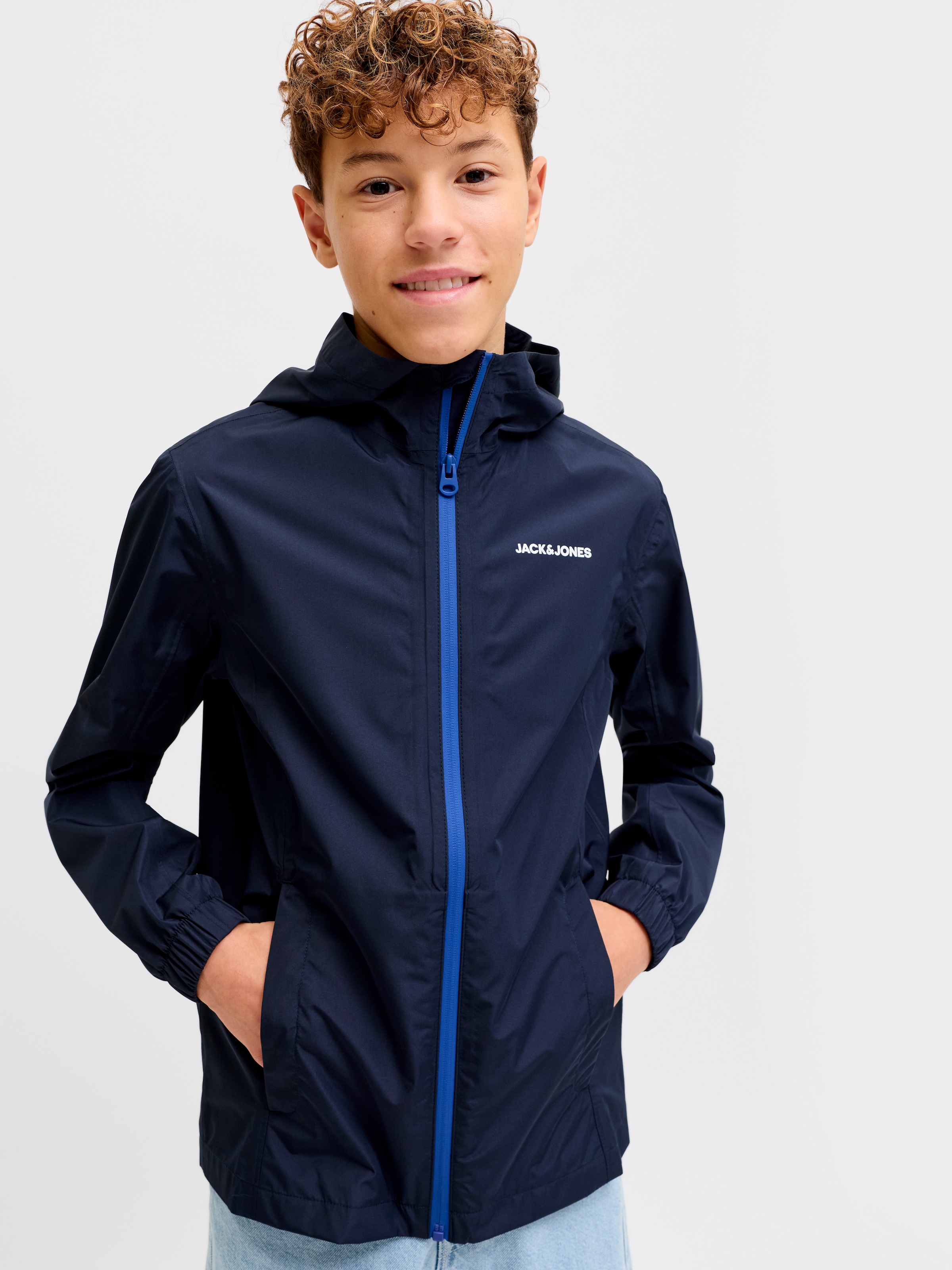 Jack & Jones Junior Regenjacke »JJEFLYNN RAIN JACKET SN JNR« mit Kapuze