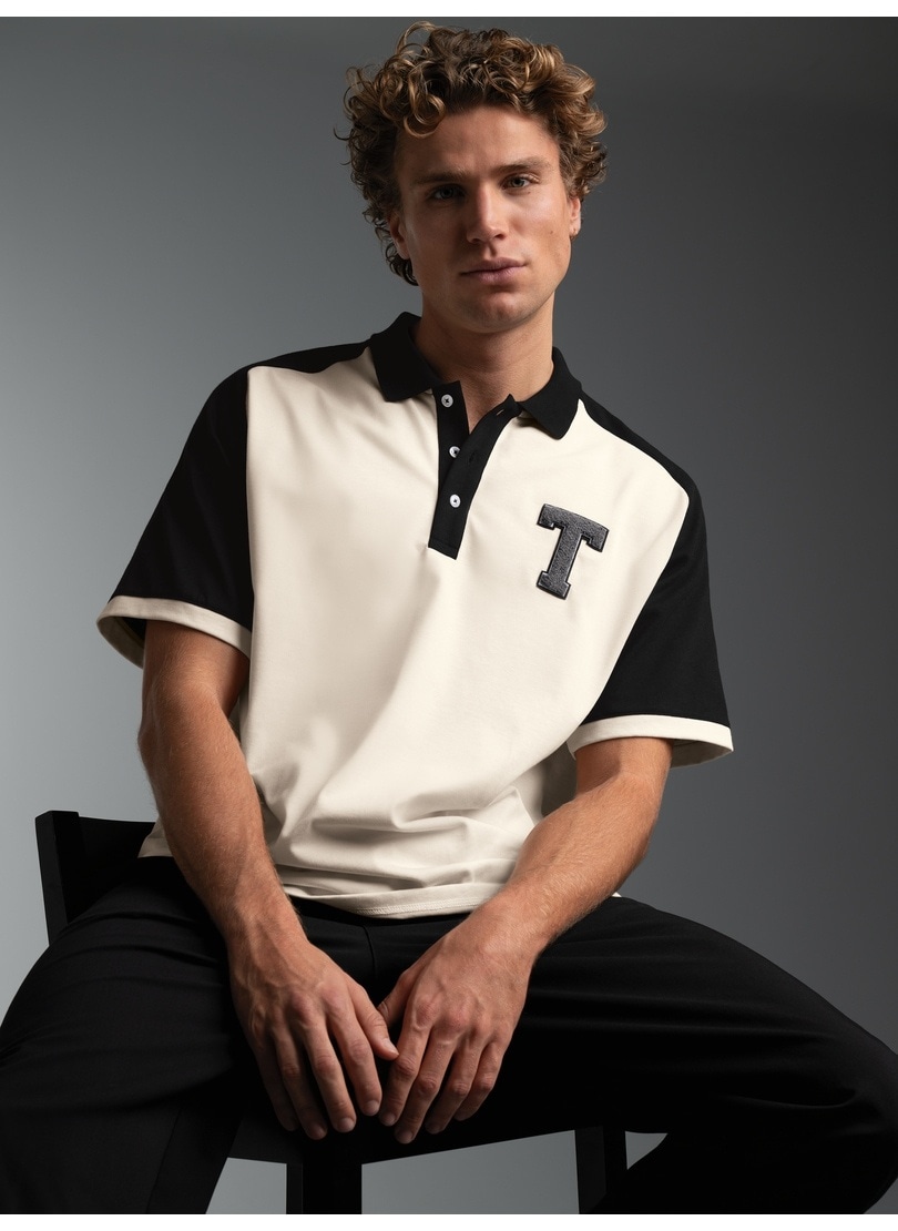 Trigema Poloshirt »TRIGEMA Oversized Raglan T Shirt mit trigema Printmotiv« 1