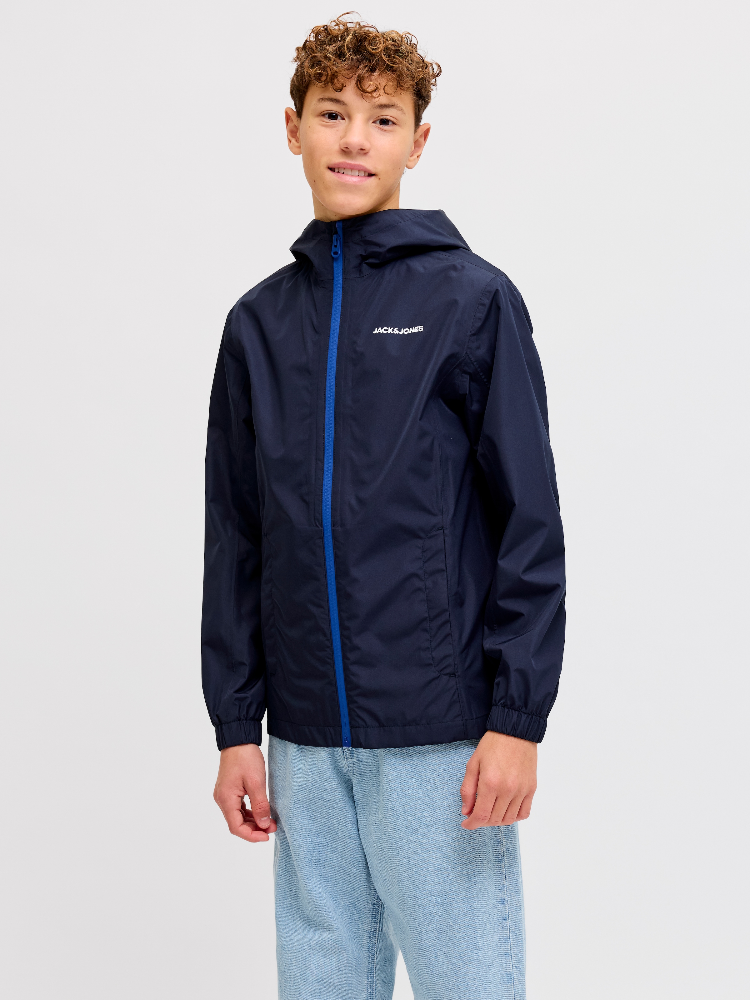 Jack & Jones Junior Regenjacke »JJEFLYNN RAIN JACKET SN JNR« mit Kapuze